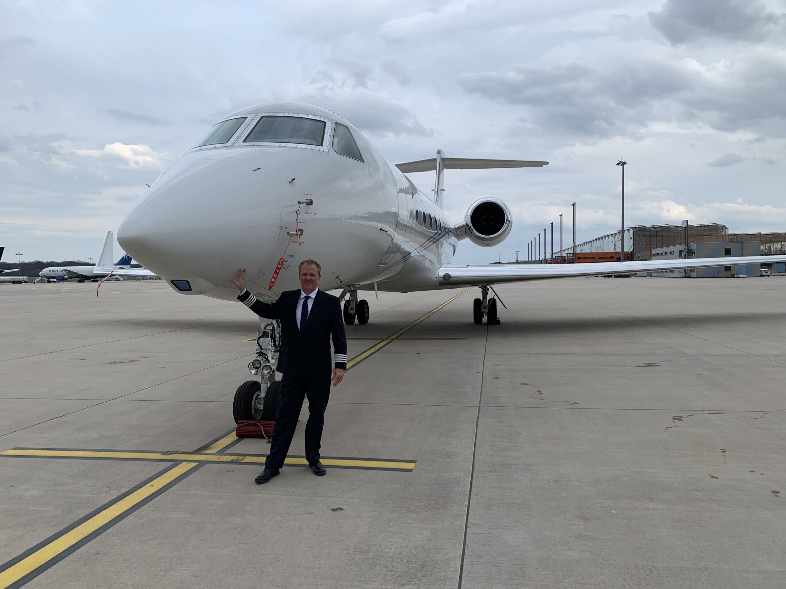 Jason E. Jacobs in a private aviation setting